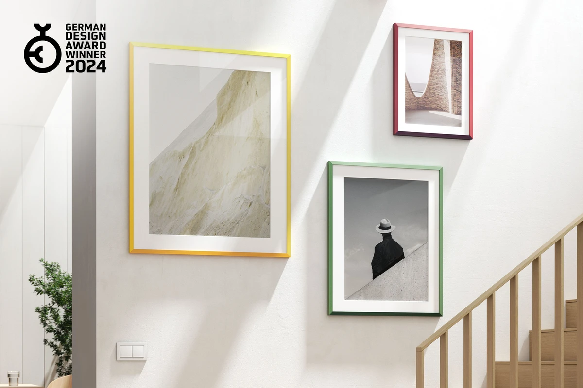Hanging arrangement of three design edition frames in different colors.