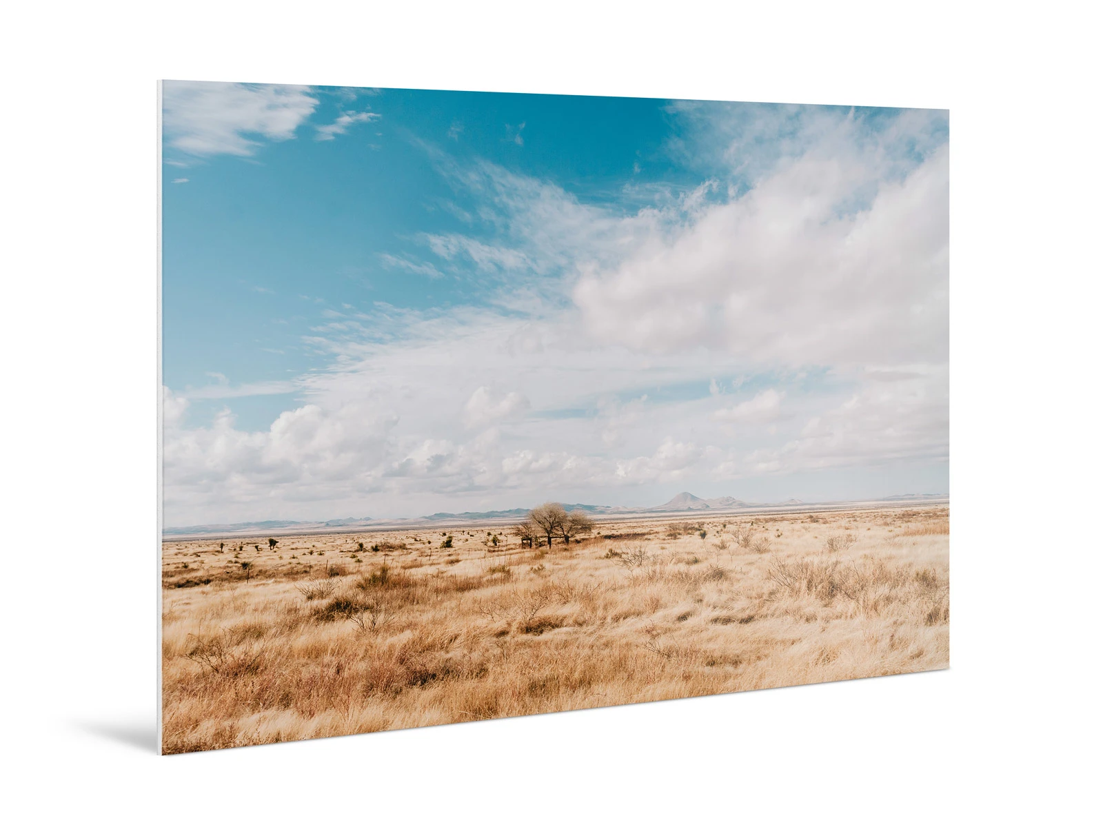Clouds drifting over a parched landscape with mountains in the background, printed on a Direct Print On Forex.