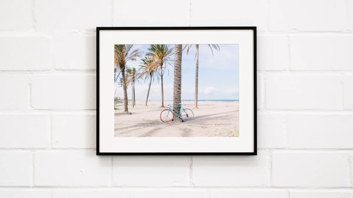 Three framed beach photographs on white wall: misty palm trees, lifeguard chair with life preserver, and tall palm tree with pink accents