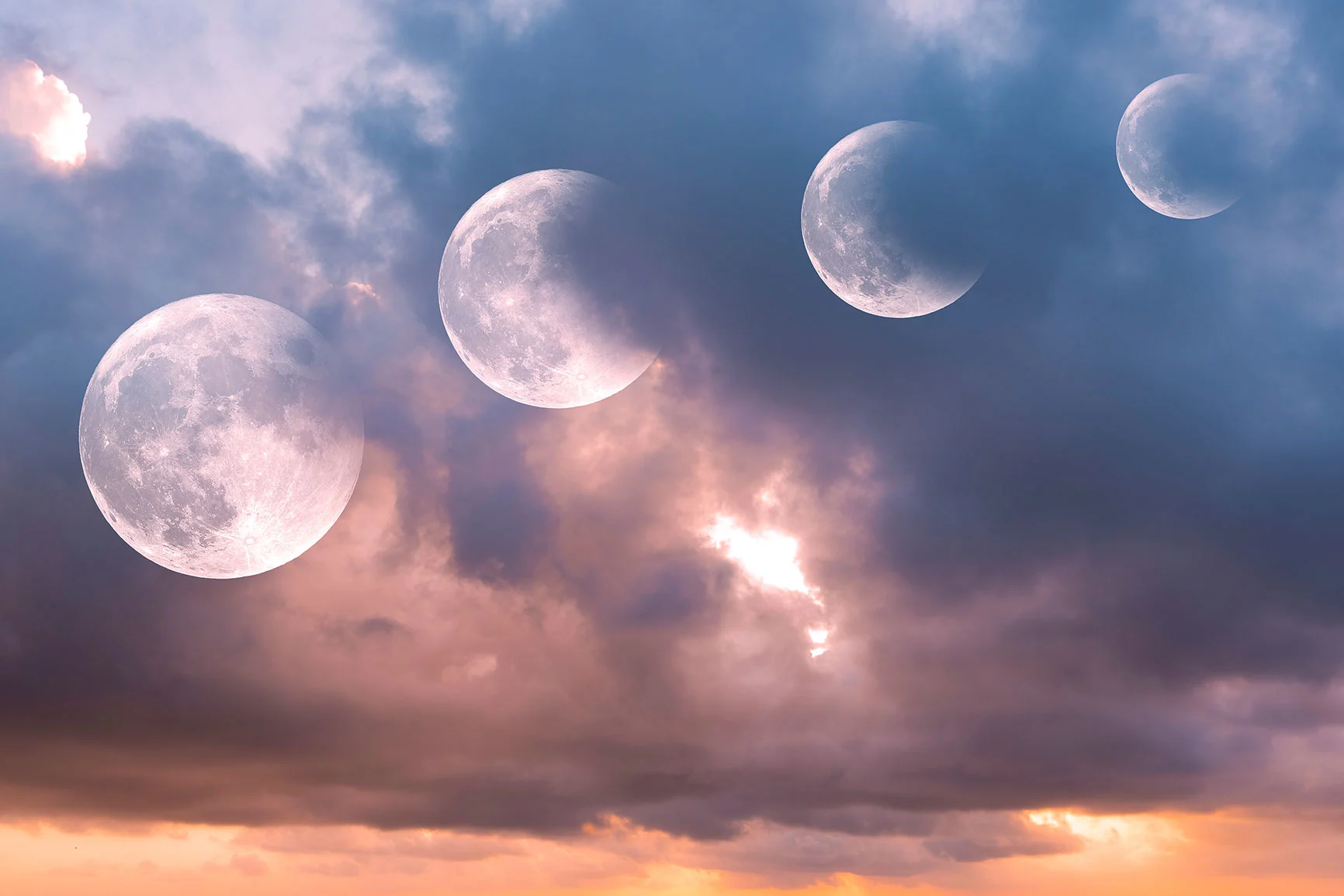 Multiple shots of the moon in different phases in a cloudy sky during sunset.