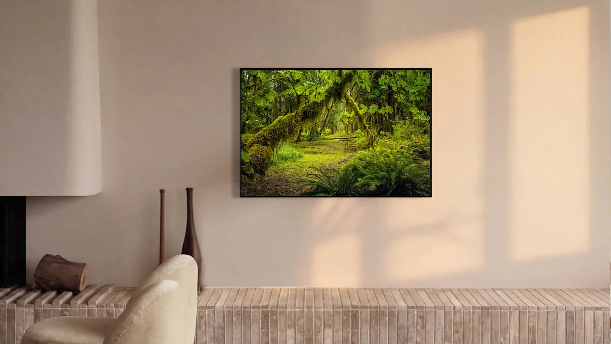 A framed photo of a lush green mossy forest path hangs on a beige wall above a stone ledge in a modern living room.