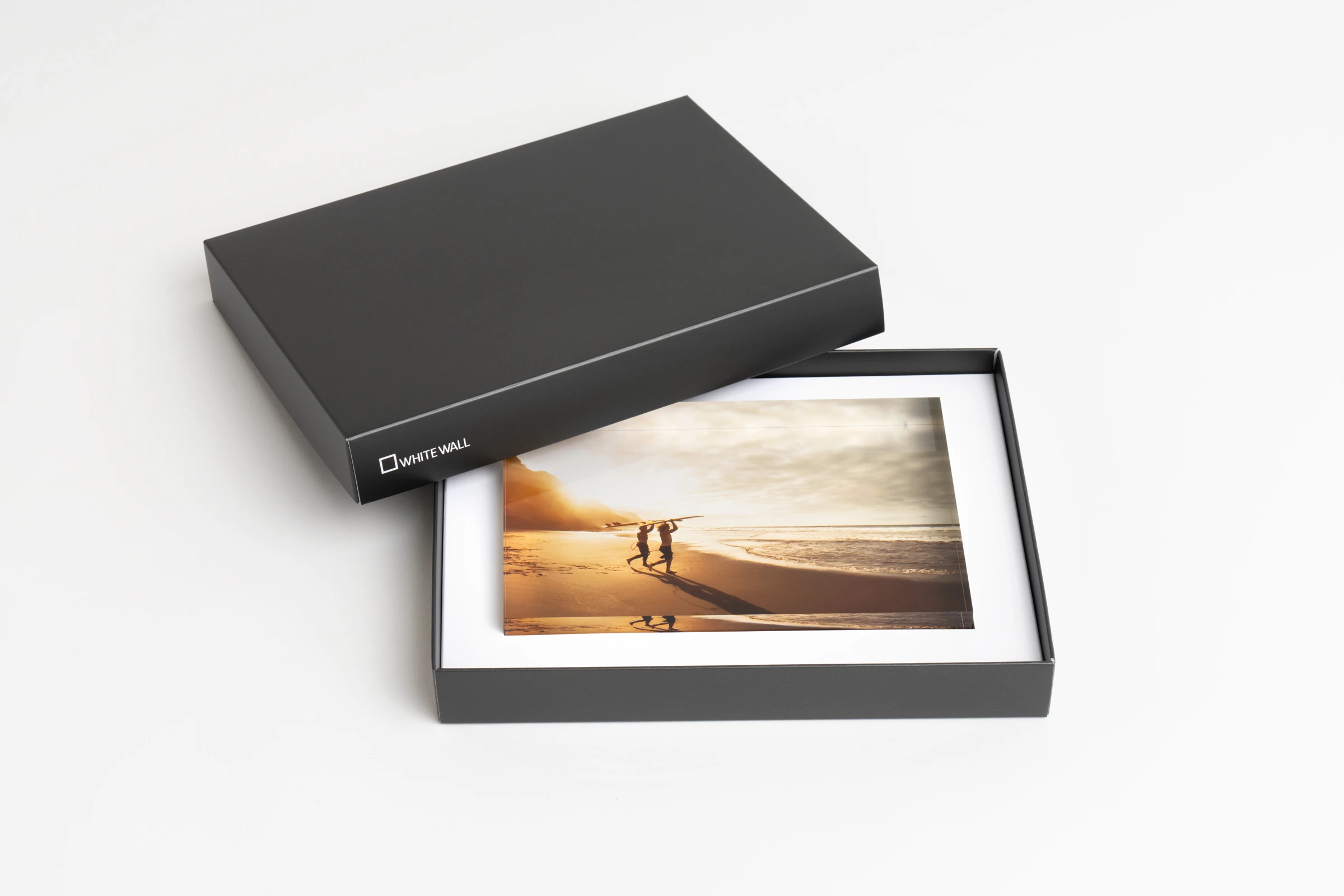 acrylic photo block lying in a black whitewall gift box.