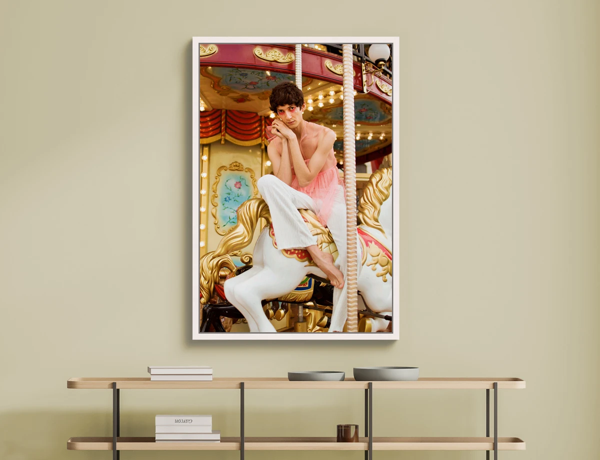 A soft portrait, male wearing female clothing, sitting in a horse carousel.