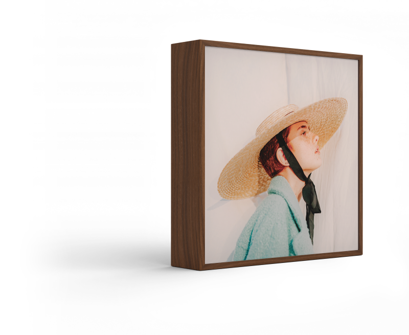 Standing ArtBox with frame color Walnut against a white background.