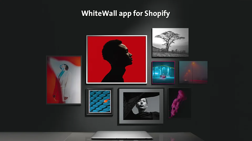 A wall with several framed pictures and the text: WhiteWall app for Shopify.