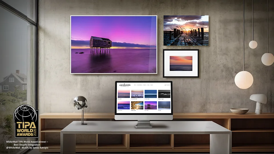 A wall with several framed pictures and the text: WhiteWall app for Shopify.