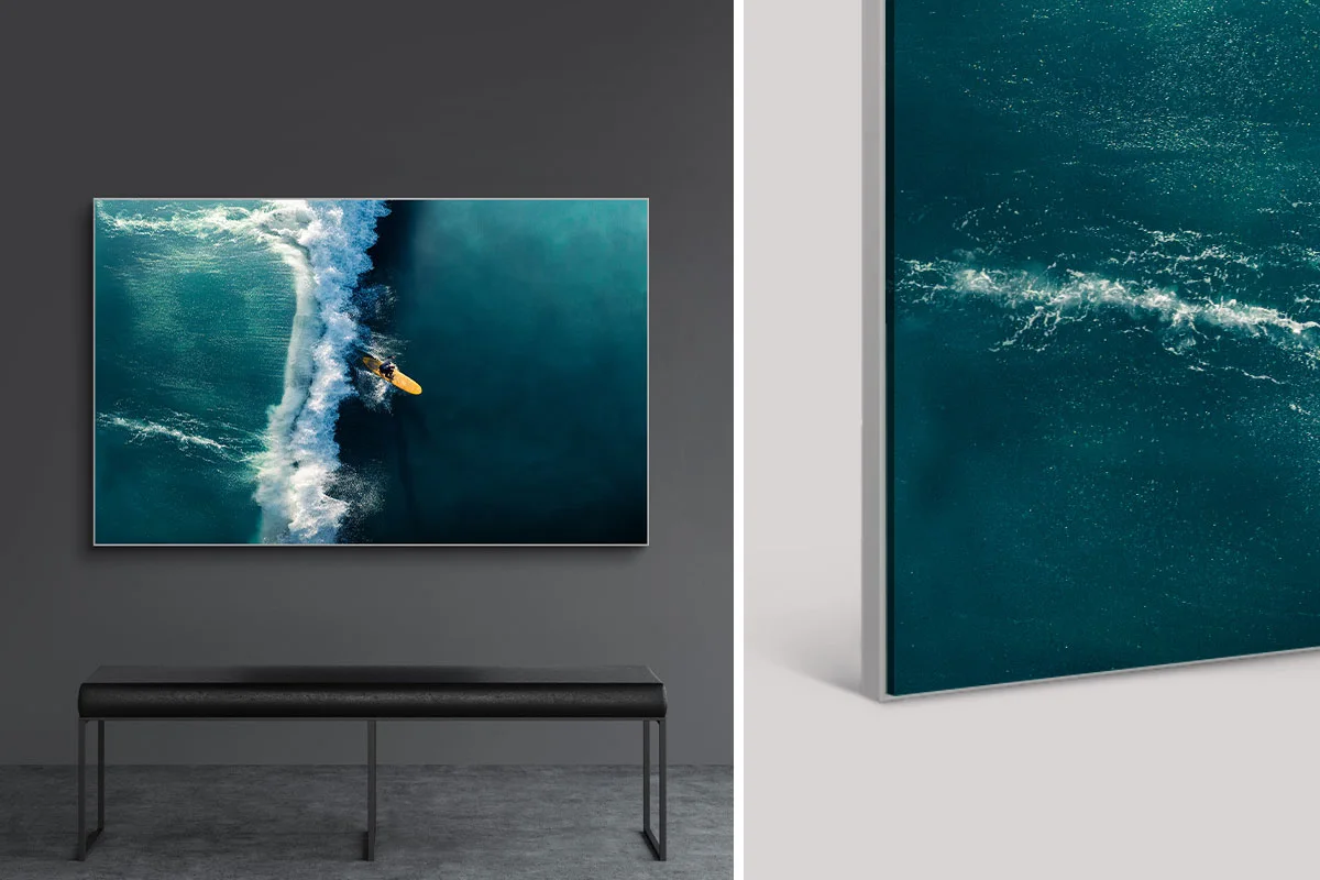 Surfers on blue water, with a close-up of waves on the surface next to them.