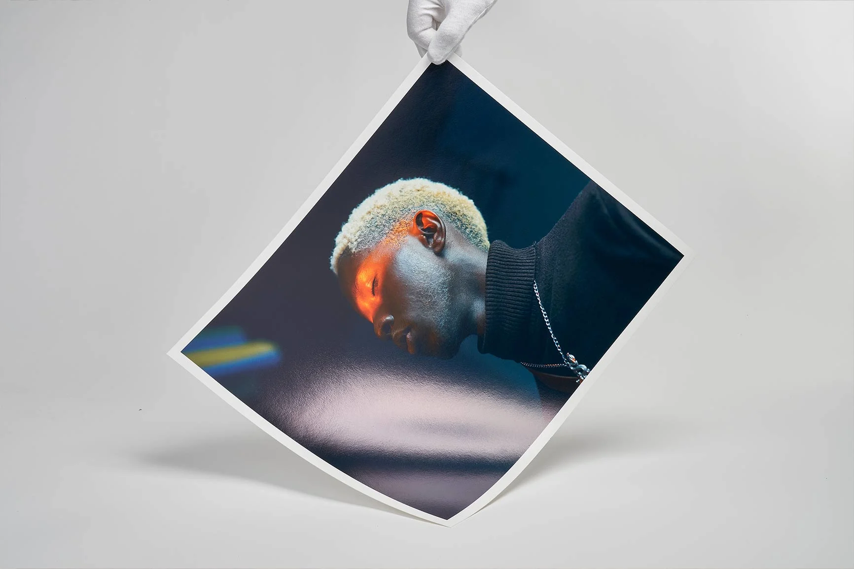 Eine Person hält ein Kunstwerk aus Fine Art Papier mit einem Porträt.