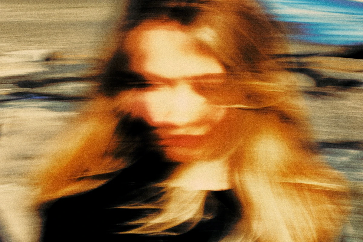 blurry face of a woman with nostalgic color grading, photo by Aleksandr Babarikin.