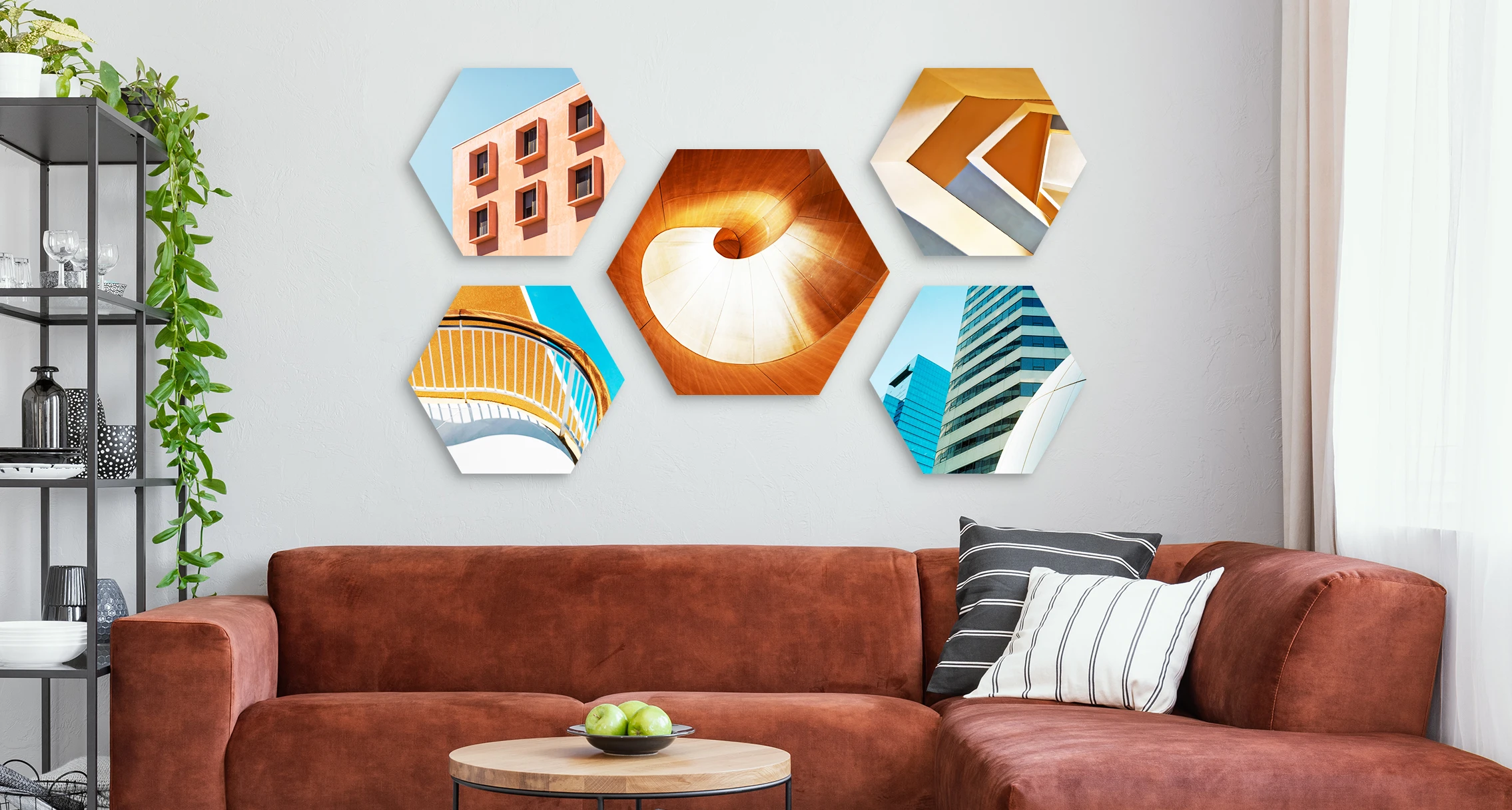 5 different architectural motifs in hexagon format hang on a wall in a living room.