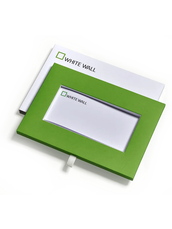 whitewall gift certificate gift box contents consisting of the gift certificate a slipcase and an envelope.