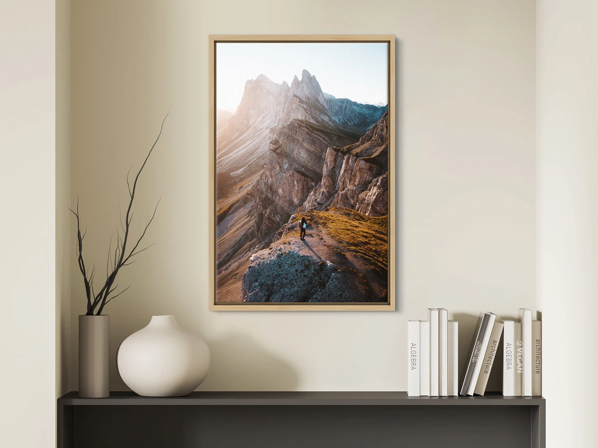 canvas print in a floater frame hanging on a wall.