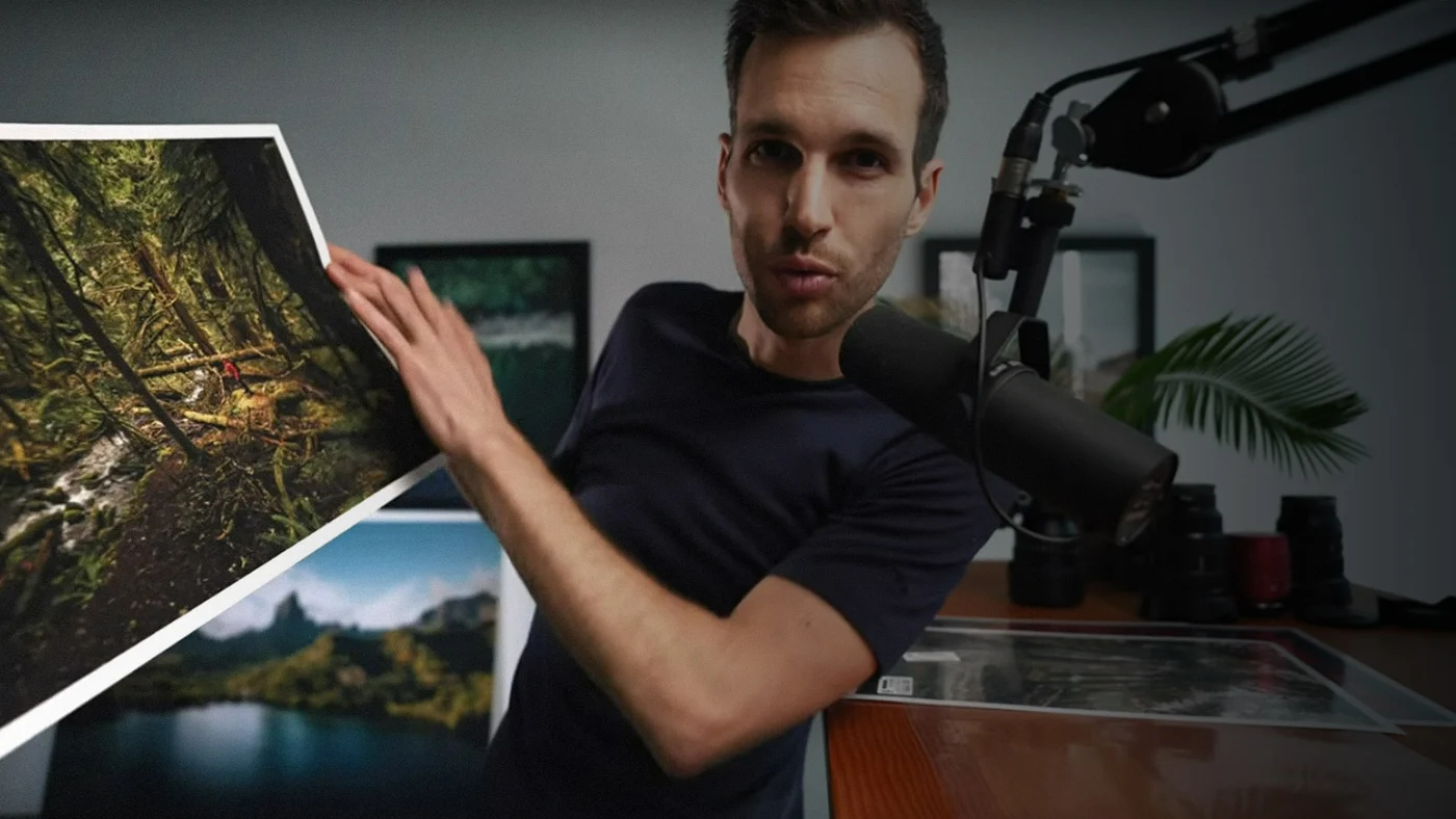 man talking in a microphone showing printed image