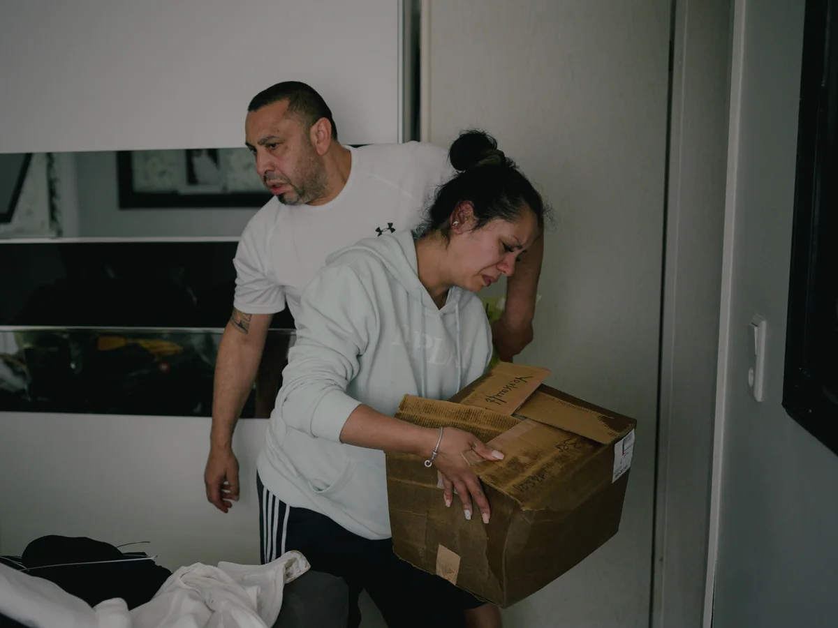 People cleaning up their apartment after the flood.