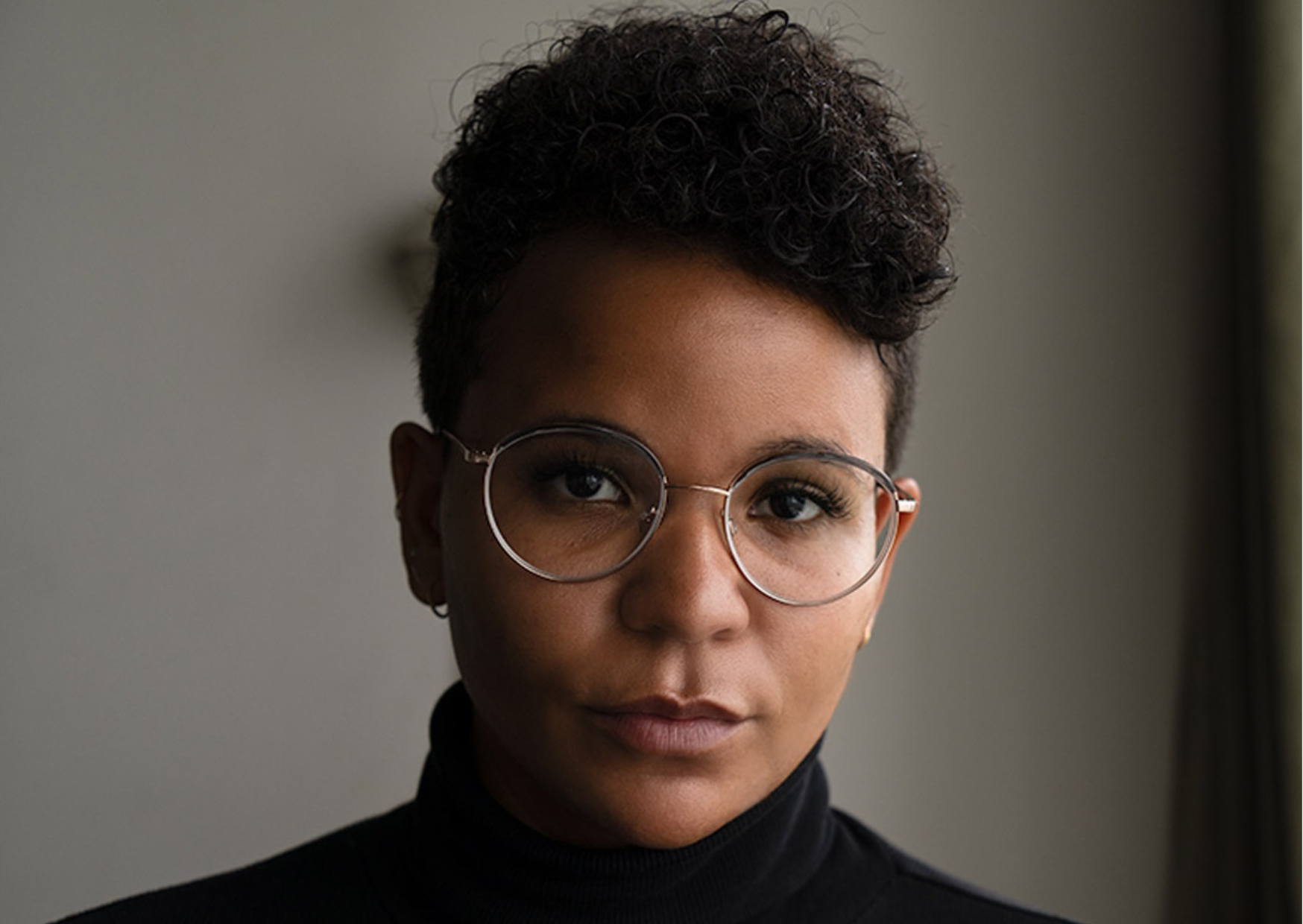 Portrait of a young woman with short hair wearing glasses