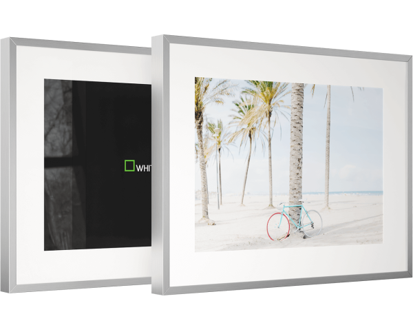 The picture shows two magnet frames. One frame has a fine art print in it. The other frame has no print.