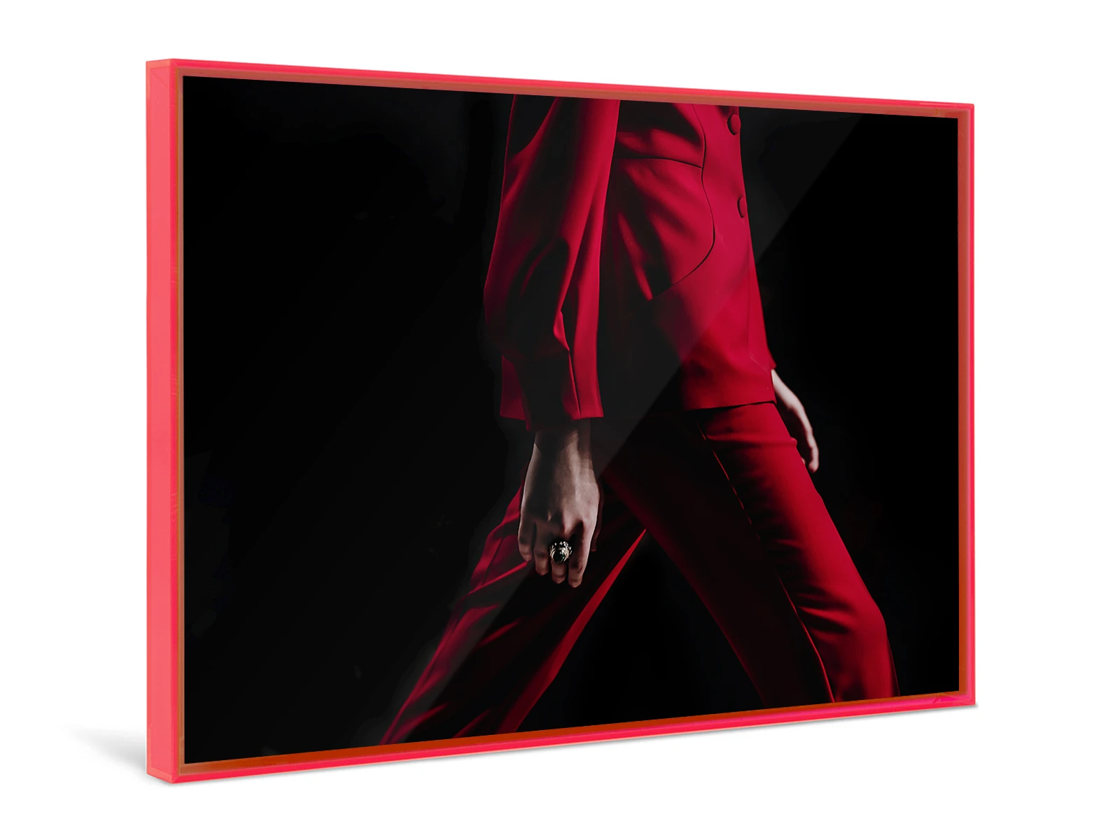 A person in a red suit walks in front of a black background framed in a red Pop Art Frame.