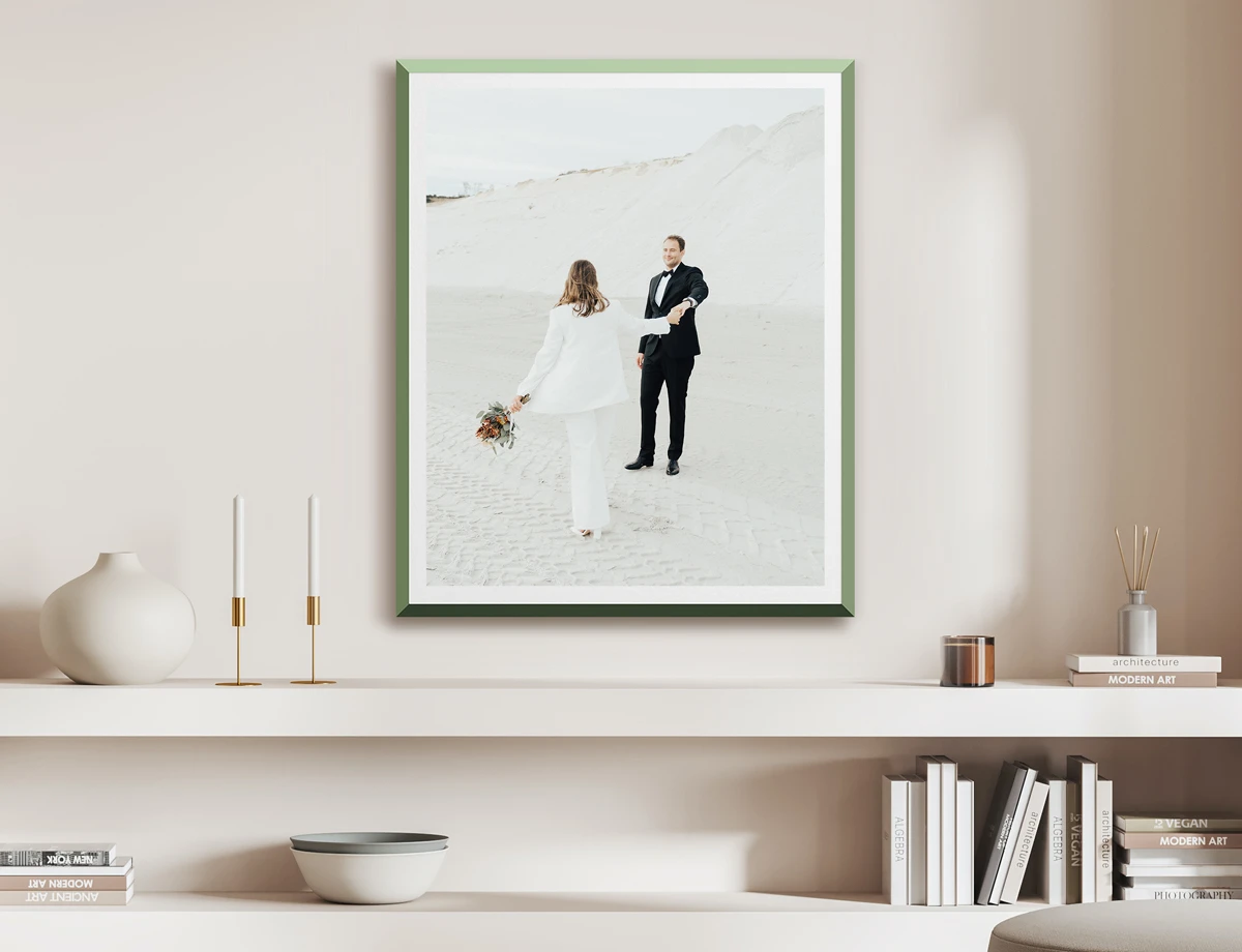 happy dancing couple outdoor shooting printed and framed in green WhiteWall Design Edition.