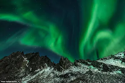 Polar lights over mountain landscape - photo by Isabelle Bacher.
