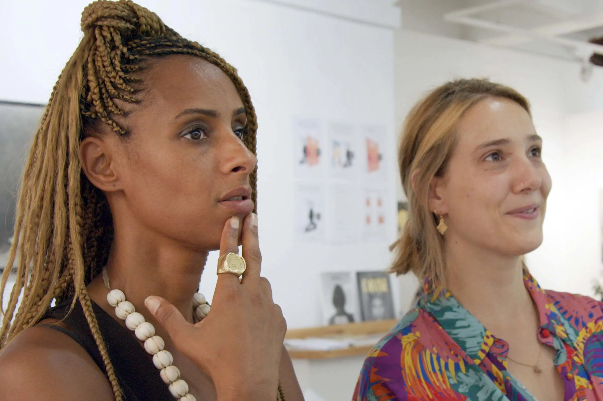 Delphine Diallo standing next to a woman in a gallery.