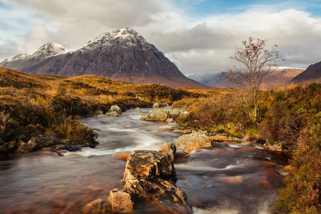 Stream flowing through mountain landscape.