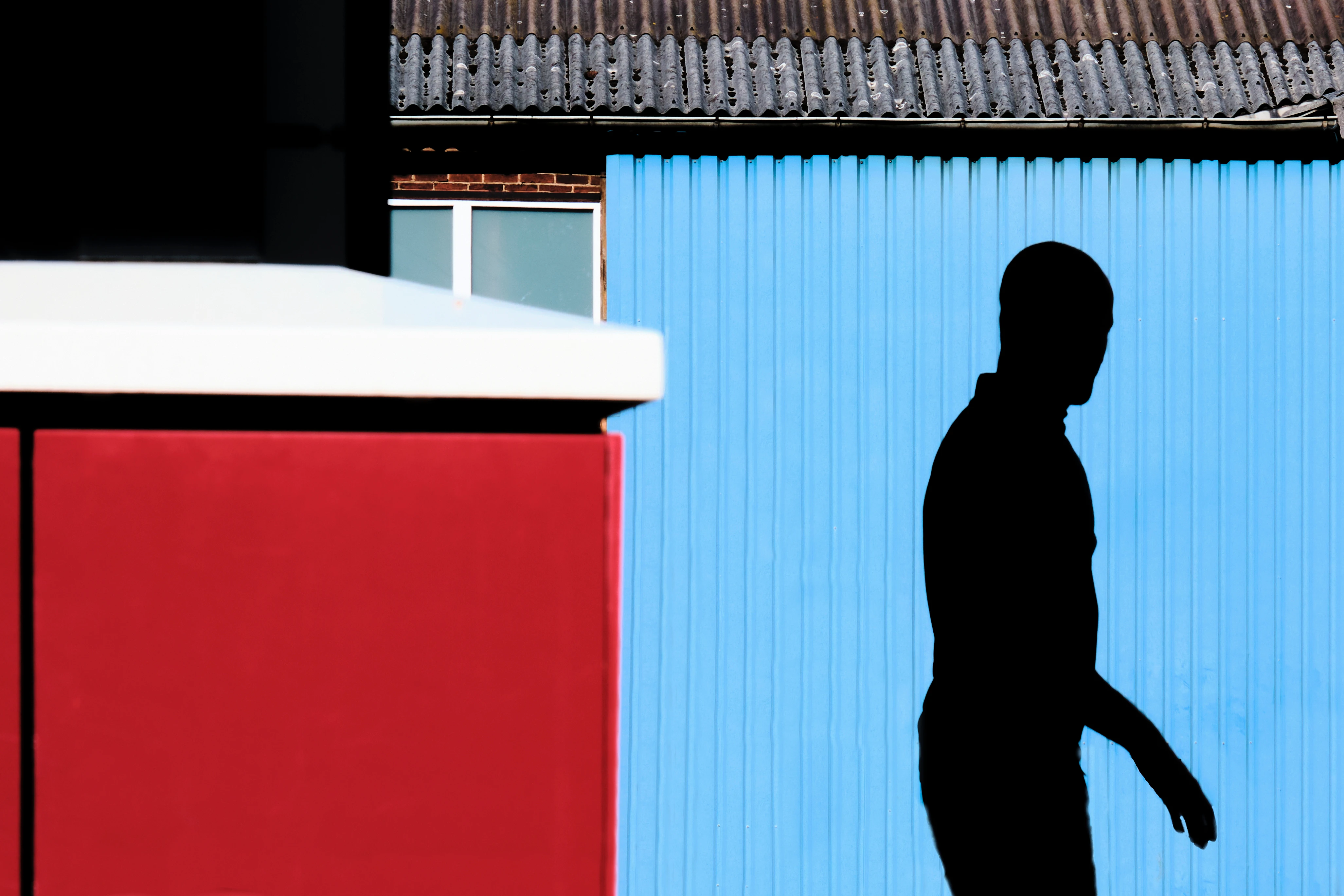 shadow of a person on a blue wall.