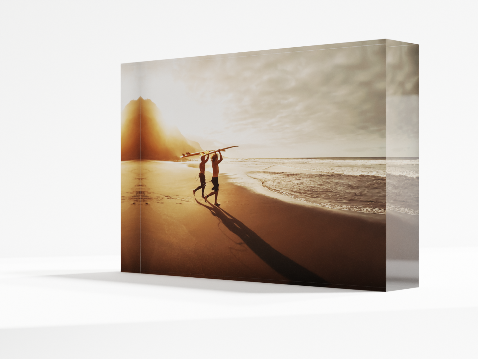 two surfers on a beach on an acrylic photo block.