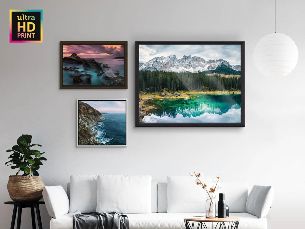 Several different motifs on a ultraHD Photo Print different frames hang on a wall in a living room.