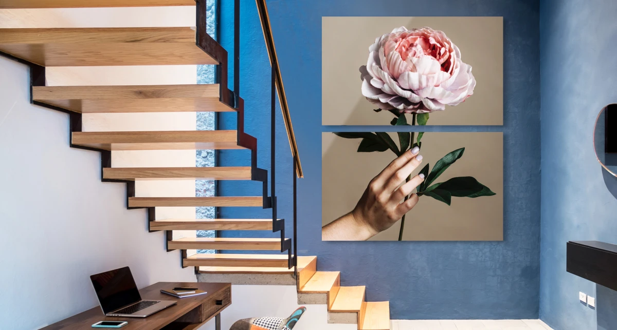 A woman holds a rose in her hand.. The whole picture is divided into two parts hanging vertically on the wall. 