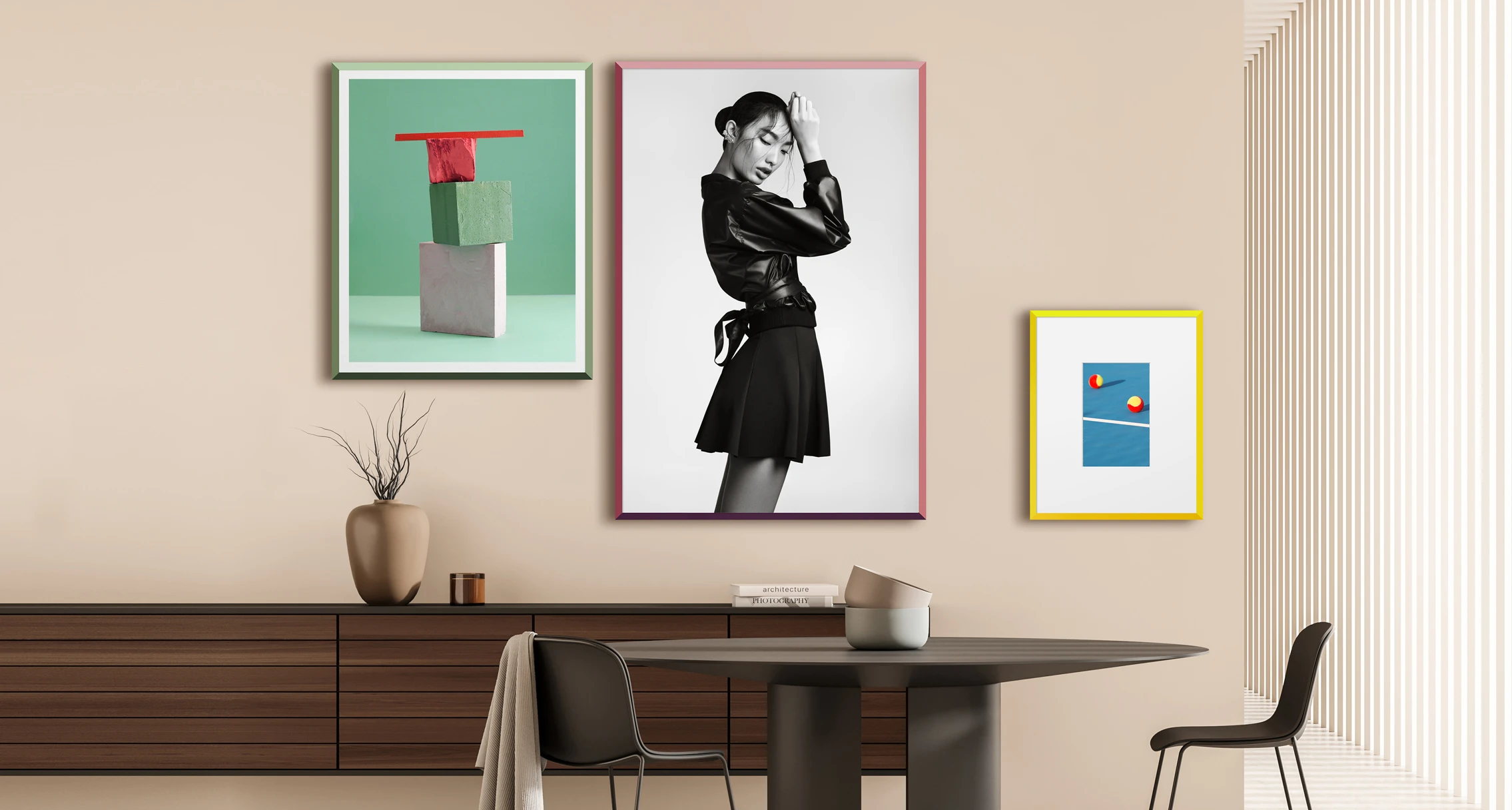 Three design edition frames, one of each color, hanging on a wall.