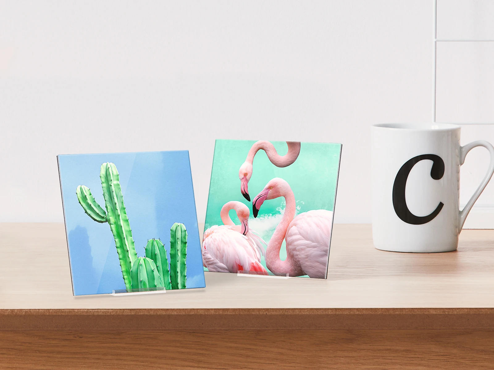 two whitewall mini acrylic prints standing on a table next to a mug.