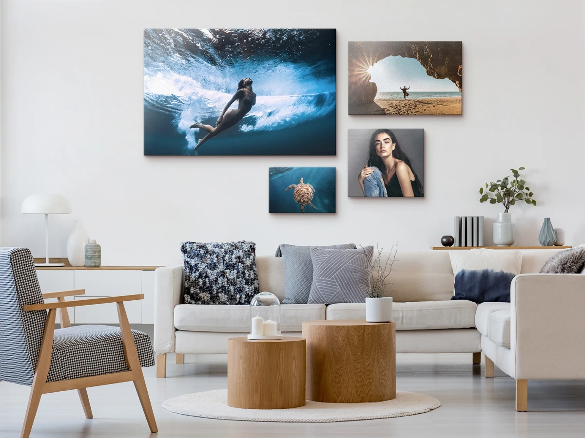 several glossy canvas prints on stretcher frames hanging on a wall.