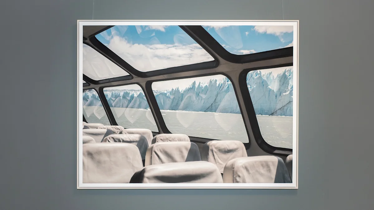 Framed photo of empty boat seats with large windows revealing a massive glacier and blue sky beyond.