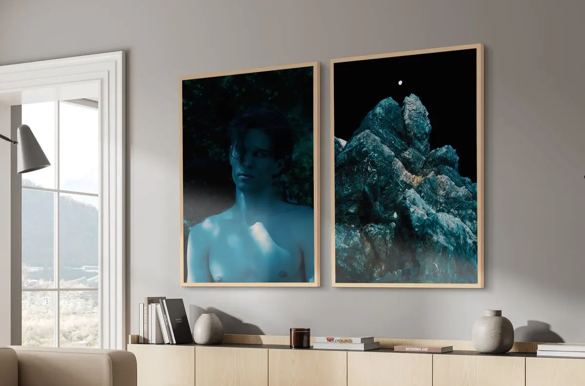 Blue-colored person and rock, two pictures in frame Hamburg in natural maple.