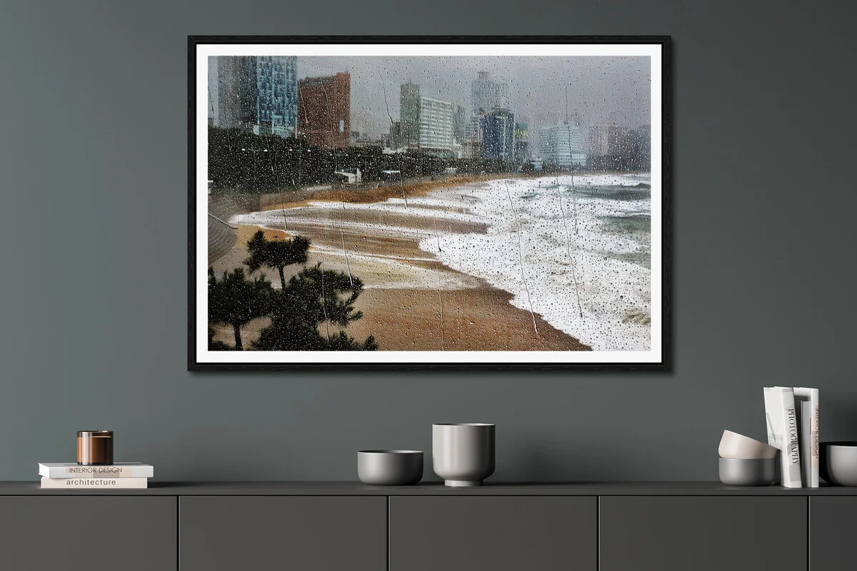 rain drops on window with beach in the background.