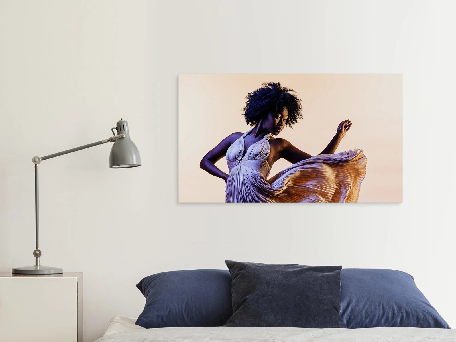 A dancing woman on an HD Metal Print on a wall in a living room.