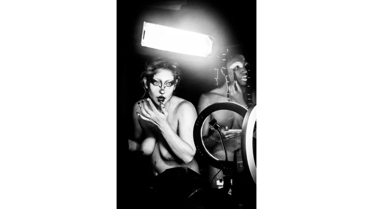 Picture taken by photographer Benita Suchodev, representing 2 persons in a club in Berlin getting ready and putting make-up on.