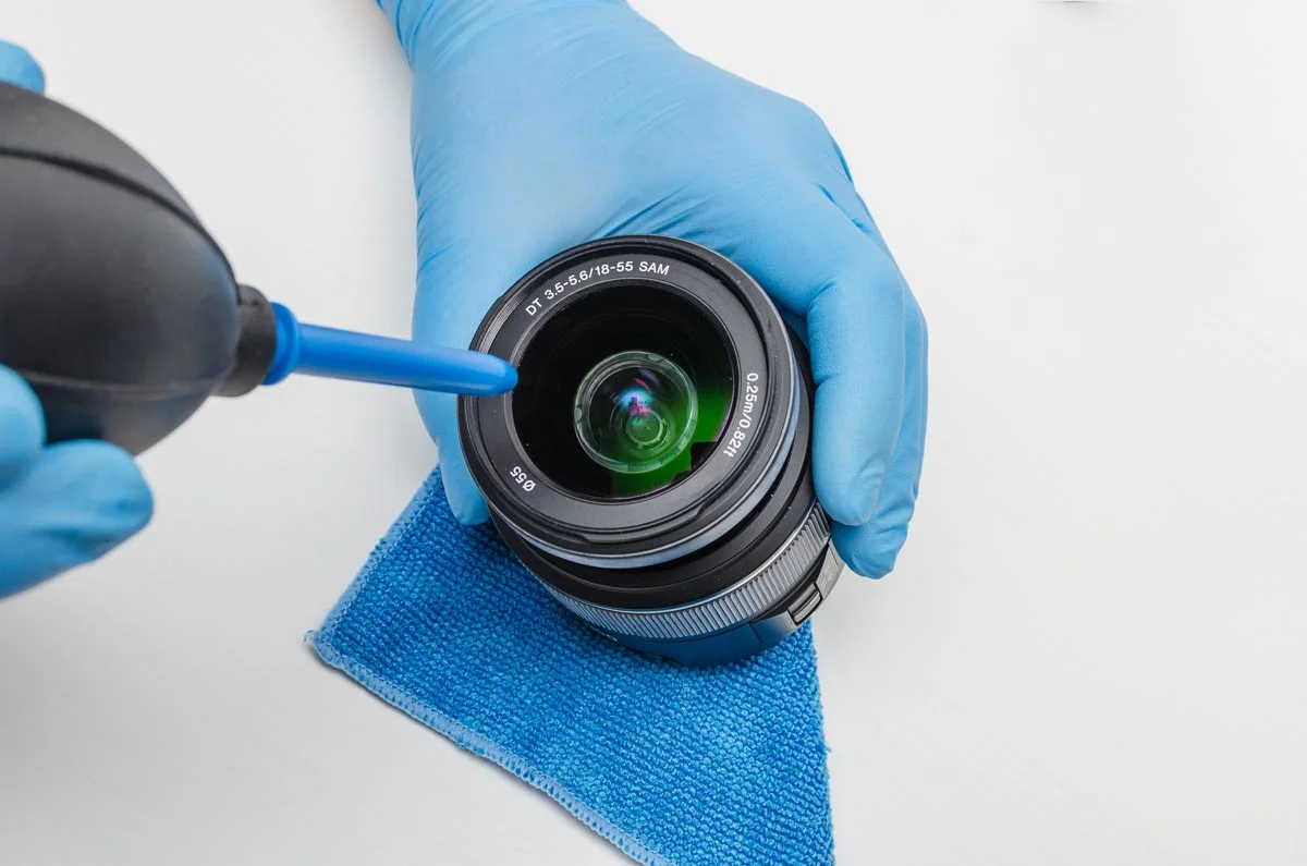 cleaning a camera lens.