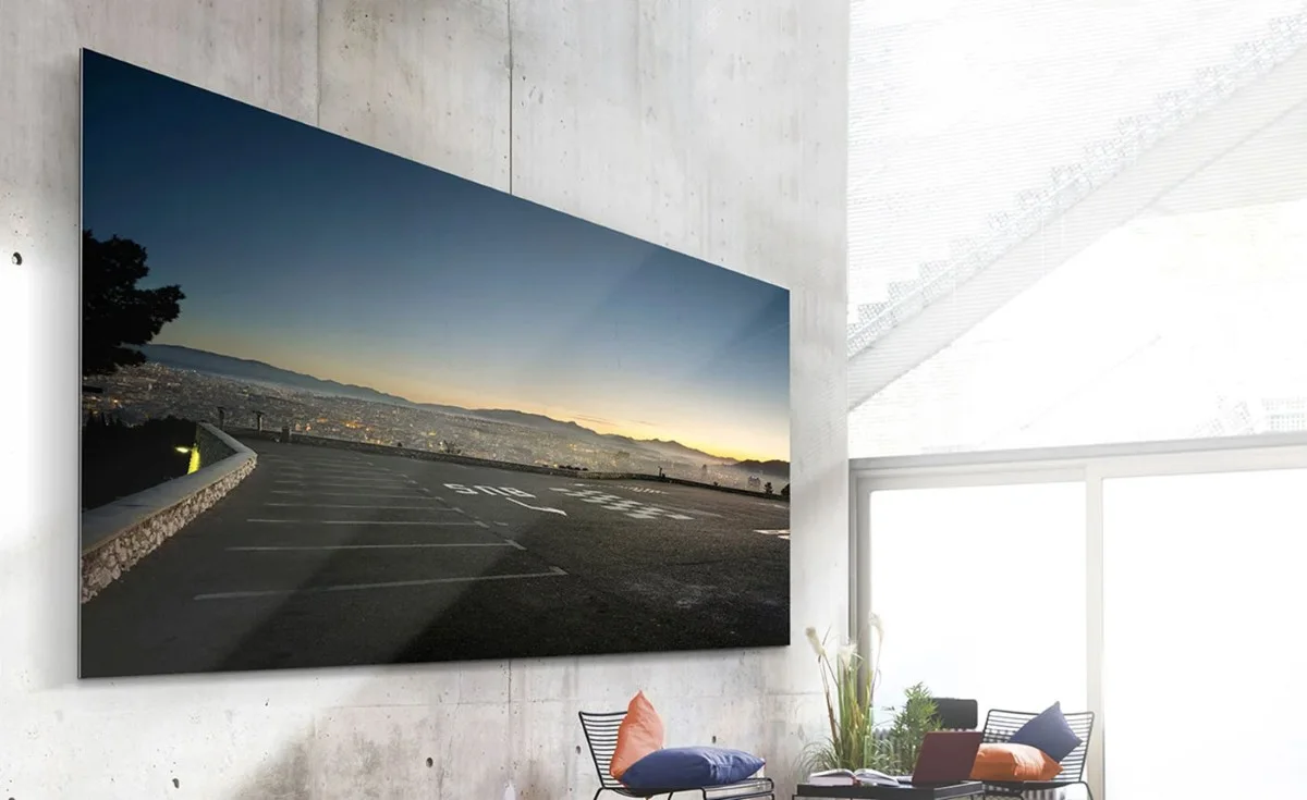 WhiteWall Masterprint on a concrete wall, showing a panoramic shot of a sunset over a city.
