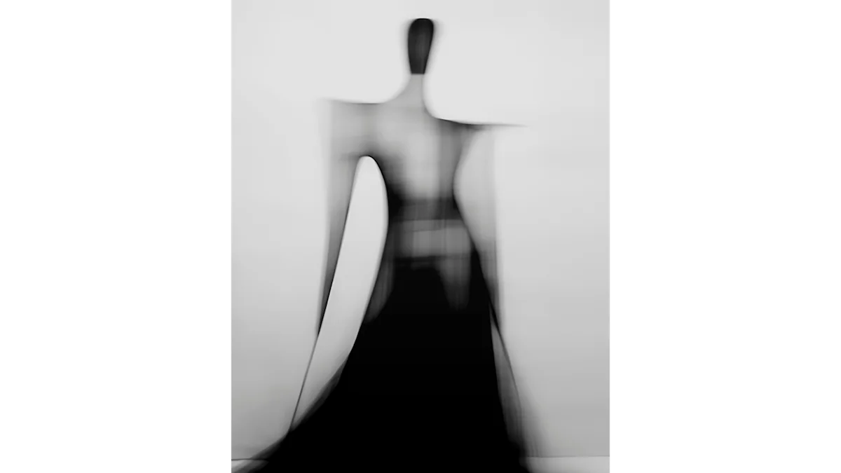Blurred outline of a woman wearing a dress photographed from behind