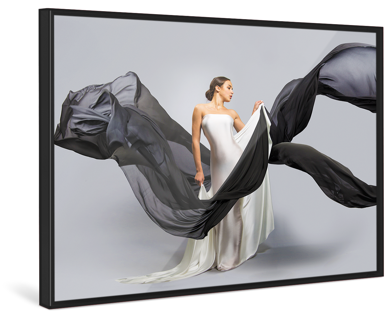 A woman in a white wedding dress holds black linen flying through the picture in a black Pop Art Frame.