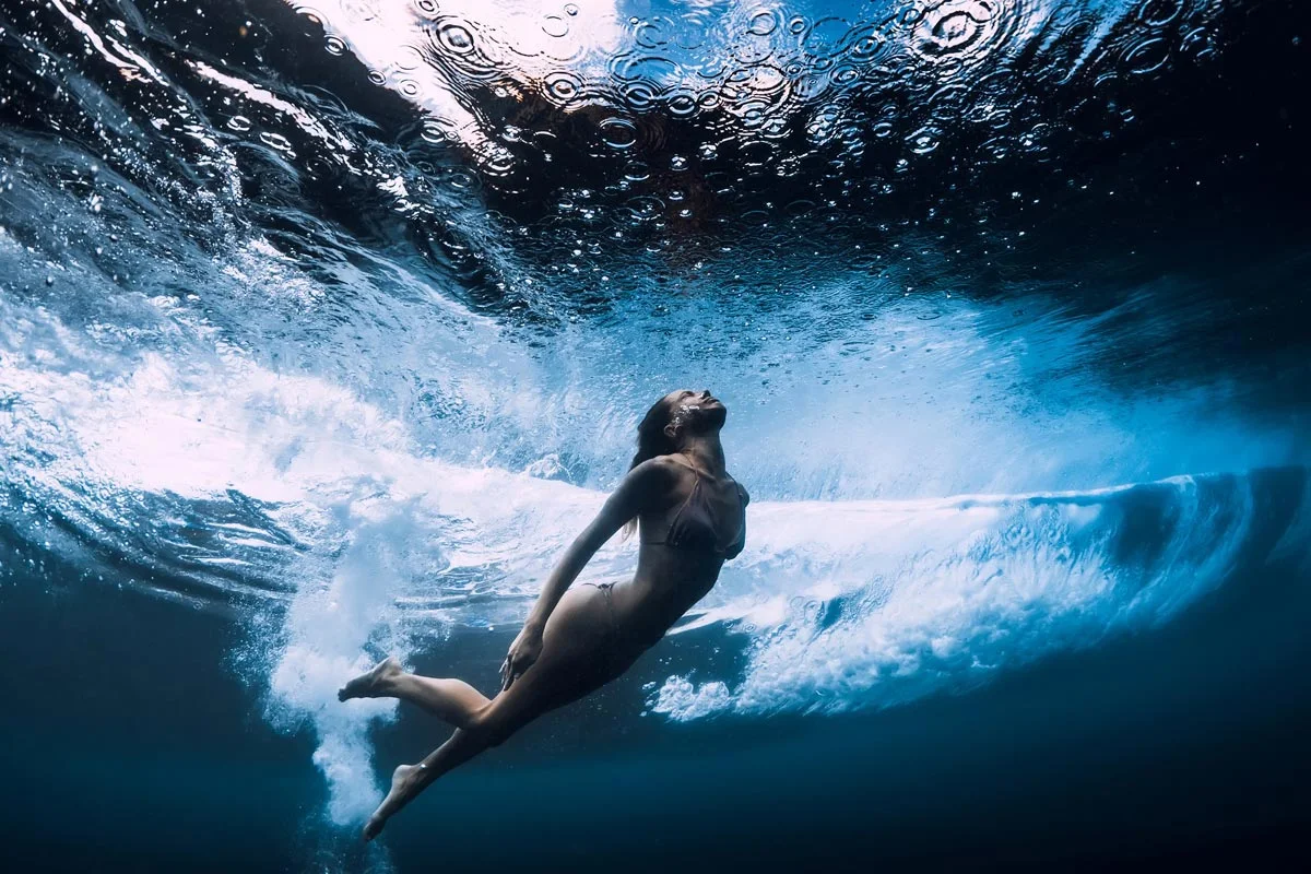 woman diving underwater.