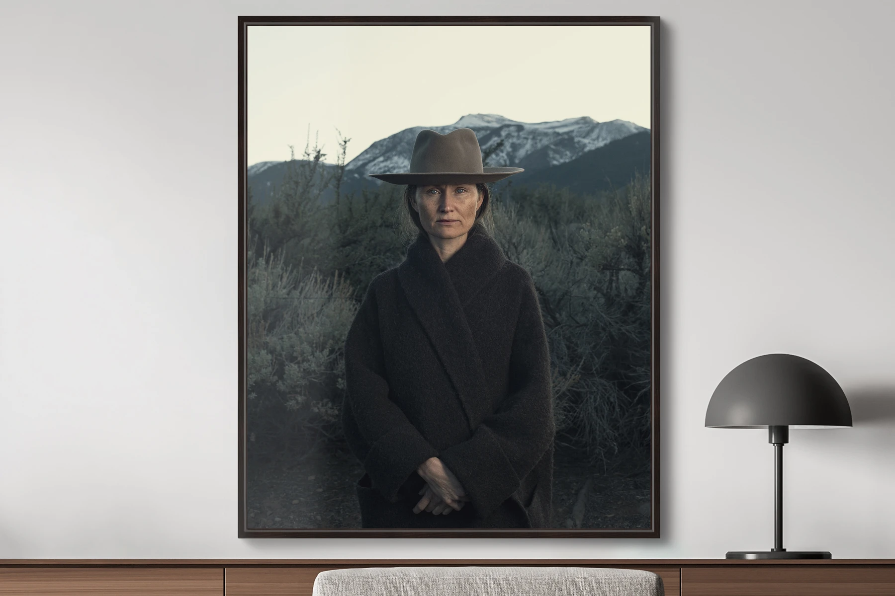portrait of a woman with a brown hat and a mountain background by josh wool.