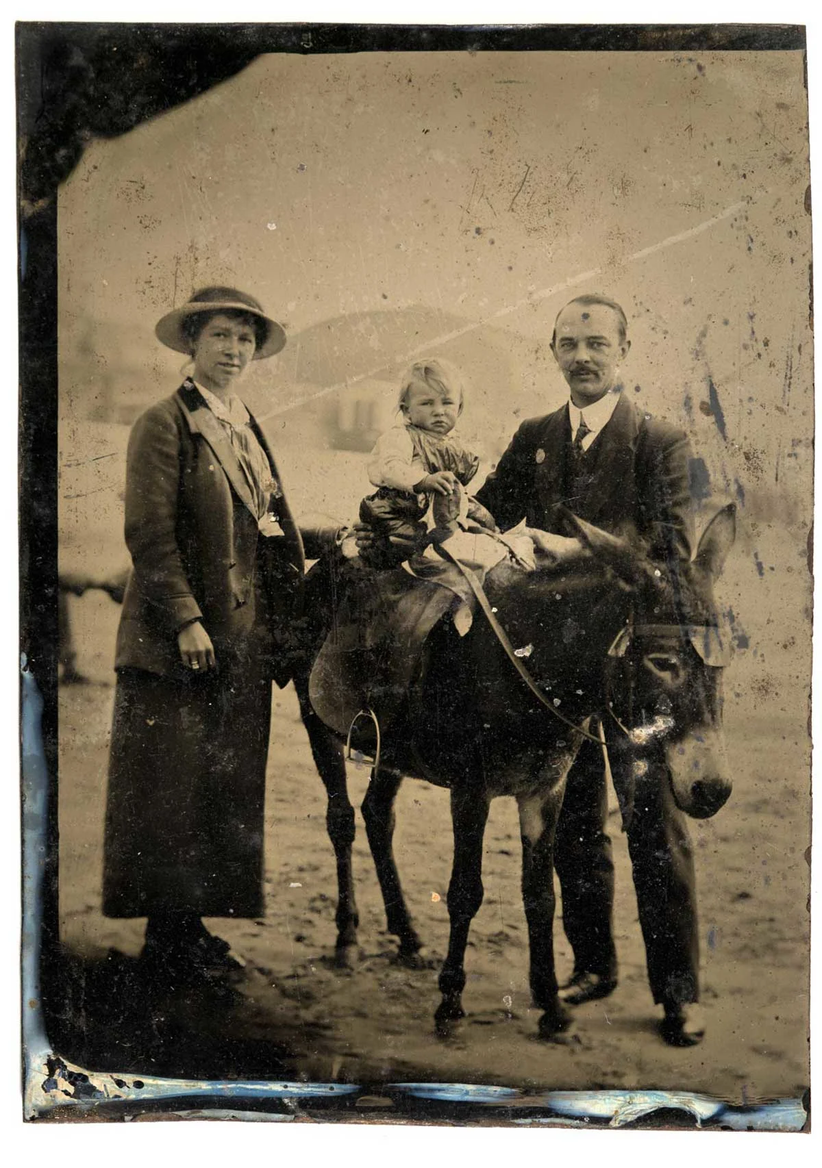 old portrait of a couple standing next to a horse