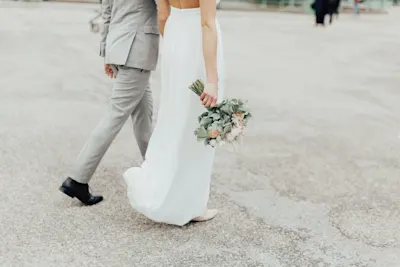 wedding couple walking along hands in hands, photo by Katharina Wergen.