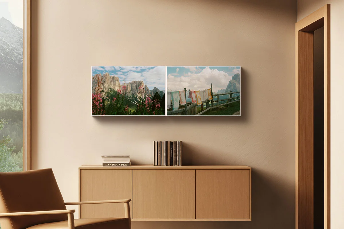 Living room with brown armchair, hanging sideboard, and two landscape paintings on the wall depicting mountains and flowers.