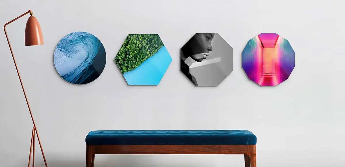 4 differently shaped wall prints hanging on a wall.