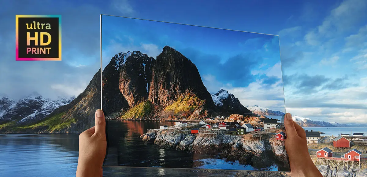 UltraHD print held in front of a landscape to demonstrate the sharpness of the resolution.