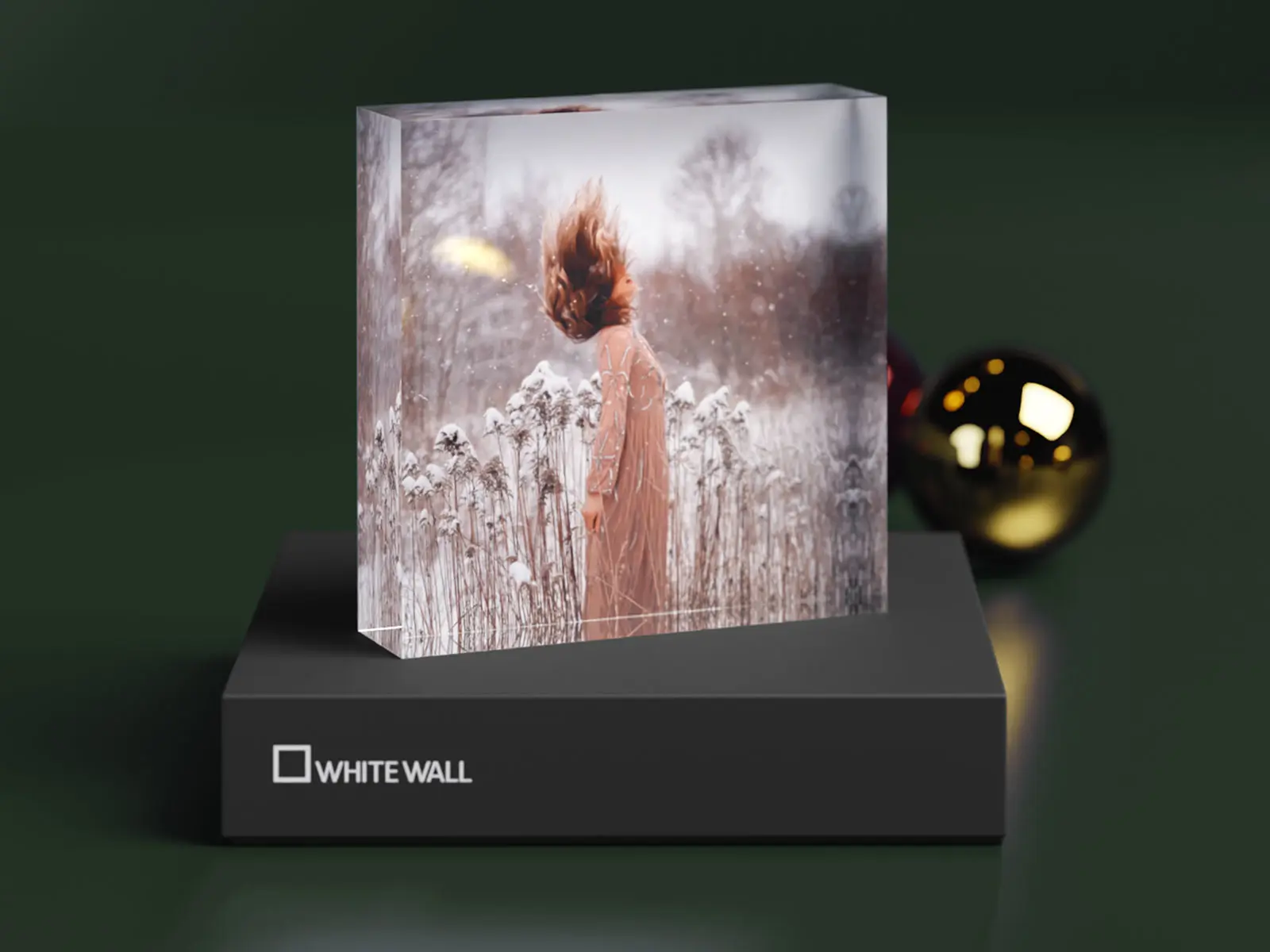acrylic photo block standing on its gift box with winter motif.