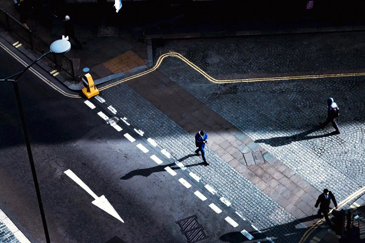 men crossing a street by night.